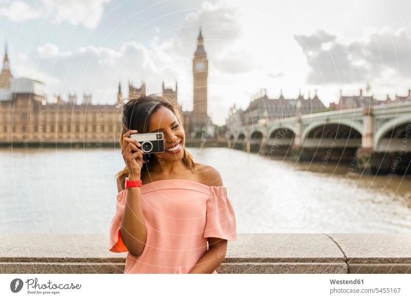 UK, London, schöne Frau beim Fotografieren in der Nähe der Westminster Bridge lächeln weiblich Frauen fotografieren Fotoapparat Kamera Fotokamera Erwachsener