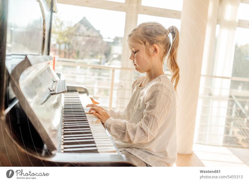 Mädchen zu Hause spielt Klavier weiblich Piano Pianos Klaviere Kind Kinder Kids Mensch Menschen Leute People Personen Musikinstrument Musikinstrumente