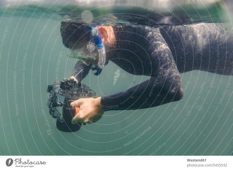 Mann taucht mit Unterwasser-DSLR-Kameratasche tauchen Männer männlich Kameras Fotoapparat Fotokamera Taucher Erwachsener erwachsen Mensch Menschen Leute People