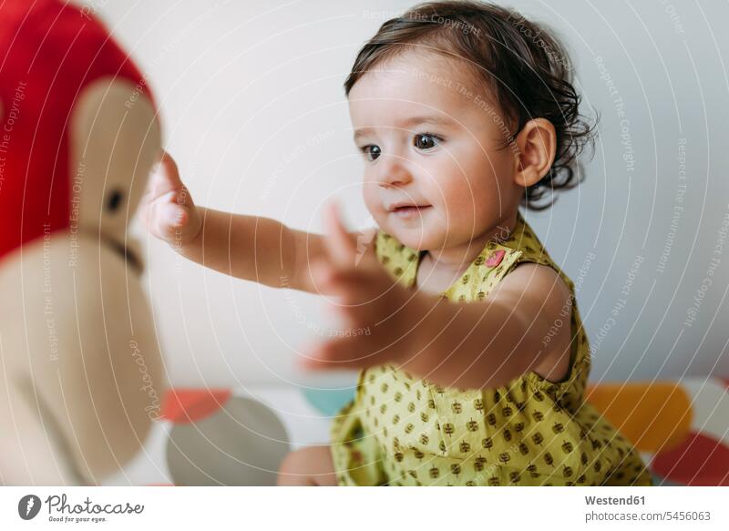 Kleines Mädchen spielt mit einem Kuscheltier spielen Baby Babies Babys Säuglinge Kind Kinder Mensch Menschen Leute People Personen braune Haare braunhaarig