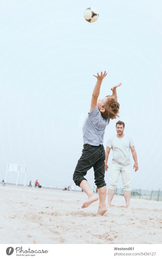Vater und kleiner Sohn spielen mit dem Ball am Strand Beach Straende Strände Beaches Papas Väter Vati Vatis Papis Söhne Eltern Familie Familien Mensch Menschen