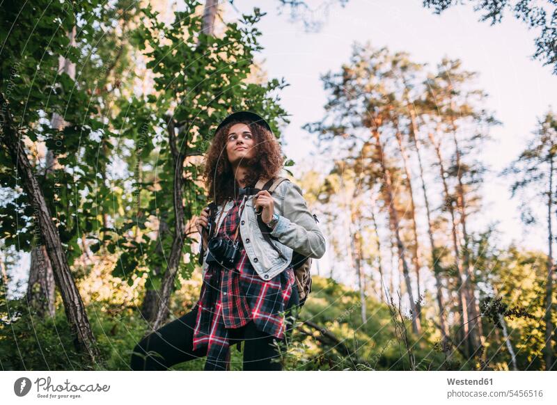 Porträt eines Teenagers mit Kamera und Rucksack in der Natur Teenagerin junges Mädchen Teenagerinnen weiblich junge Frau Wald Forst Wälder Jugendliche