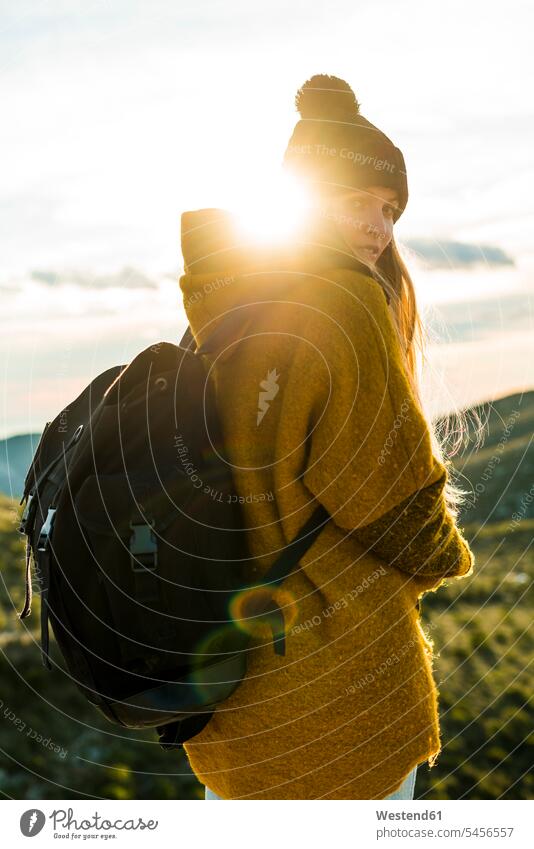 Porträt einer jungen Frau mit Rucksack in der Natur bei Sonnenuntergang weiblich Frauen Erwachsener erwachsen Mensch Menschen Leute People Personen Rucksäcke