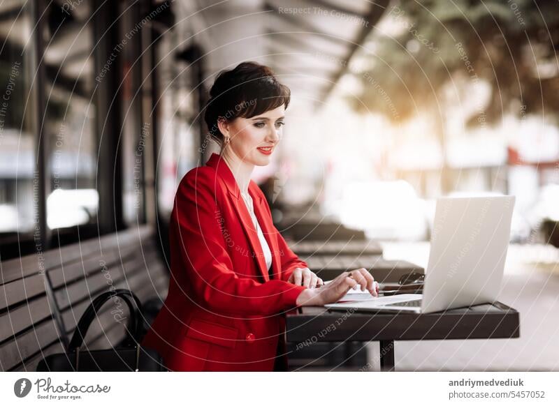 Junge zuversichtlich, Geschäftsfrau mit Laptop-Computer arbeiten im Freien, mit Video-Anruf mit Kunden oder Mitarbeiter sitzen im Café Terrasse. Erfolgreiches Geschäft. Online-Meeting, Videokonferenz-Konzept