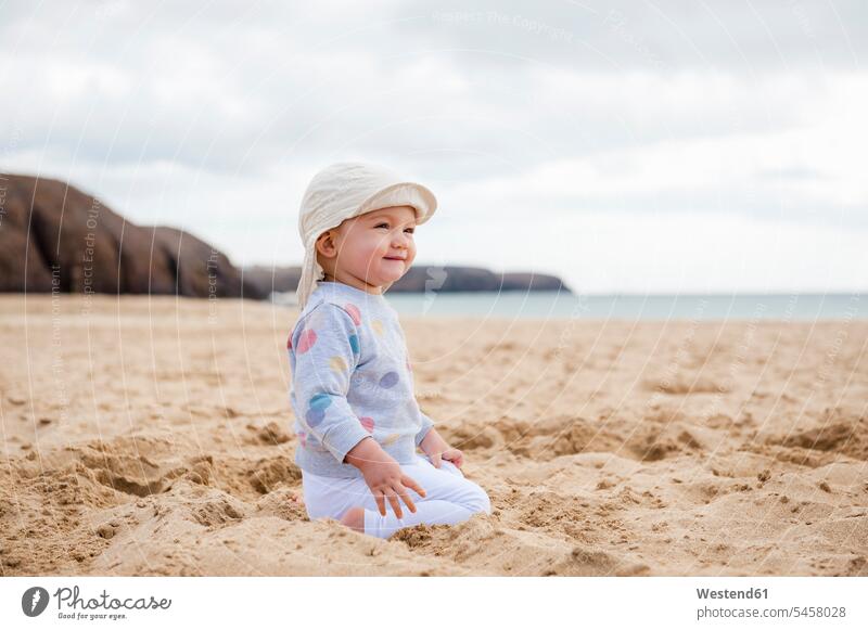 Spanien, Lanzarote, zufriedenes, am Strand kauerndes Mädchen Beach Straende Strände Beaches Baby Babies Babys Säuglinge Kind Kinder Zufriedenheit hocken