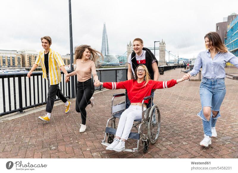 Fröhliche Männer und Frauen mit behinderter Freundin genießen in der Stadt, London, UK Farbaufnahme Farbe Farbfoto Farbphoto Außenaufnahme außen draußen