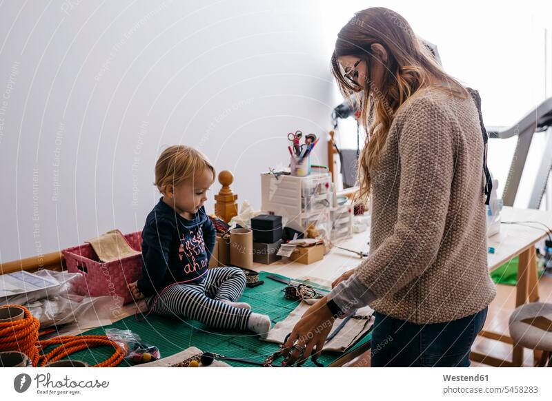 Mutter mit kleiner Tochter zu Hause arbeiten mit Mode-Accessoires Zuhause Kind Familie Mensch Eltern Kreative Bildung Handarbeit Designerin Fürsorge Beruf Tisch