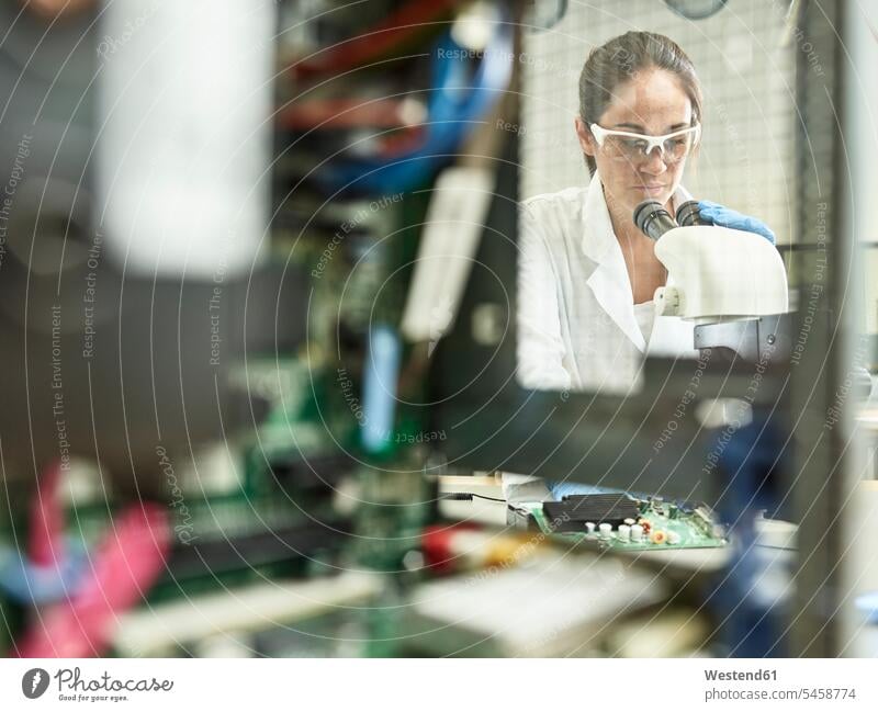 Weibliche Technikerin, die im Forschungslabor mit dem Mikroskop arbeitet Technikerinnen Techniken Technologie Forscherin Ingenieurin Ingenieurinnen Beruf