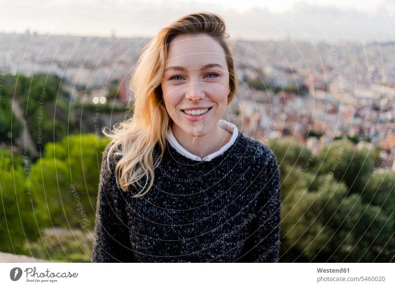 Porträt einer lächelnden jungen Frau bei Sonnenaufgang über der Stadt, Barcelona, Spanien Leute Menschen People Person Personen Europäisch Kaukasier kaukasisch