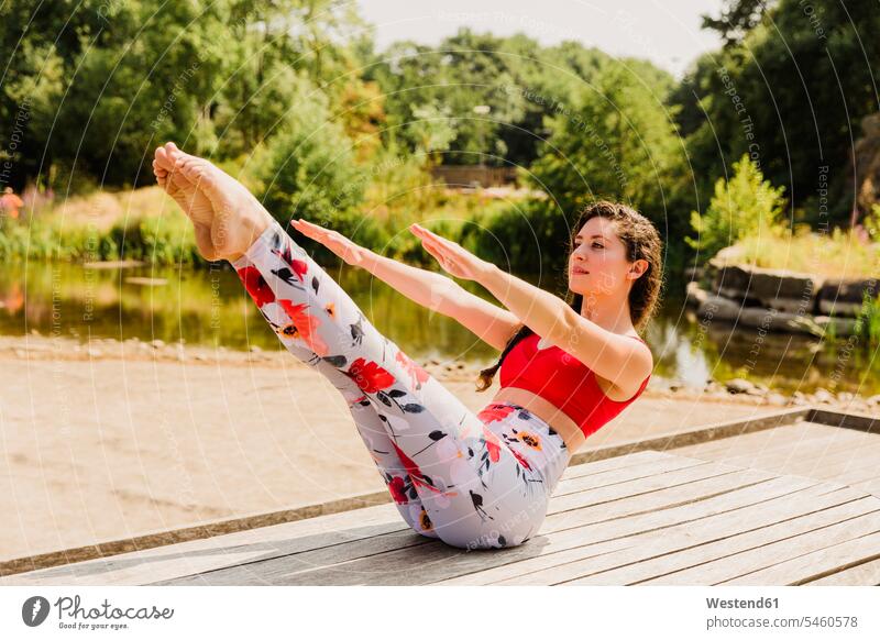 Junge Frau übt Pilates in einem Stadtpark Trainieren Übung Üben Übungen Gesunder Lebensstil Gesundheitsbewusstsein gesunde Lebensweise Freizeit Muße