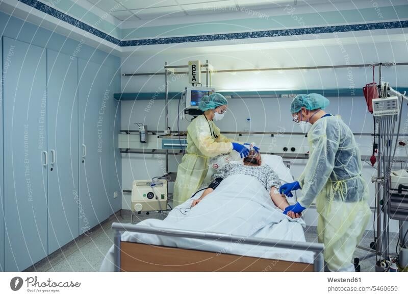 Ärzte, die Patienten auf der Notfallstation eines Krankenhauses betreuen, wechseln die Atmung von Sauerstoffmaske auf Beutelventilmaske Arbeitskollege