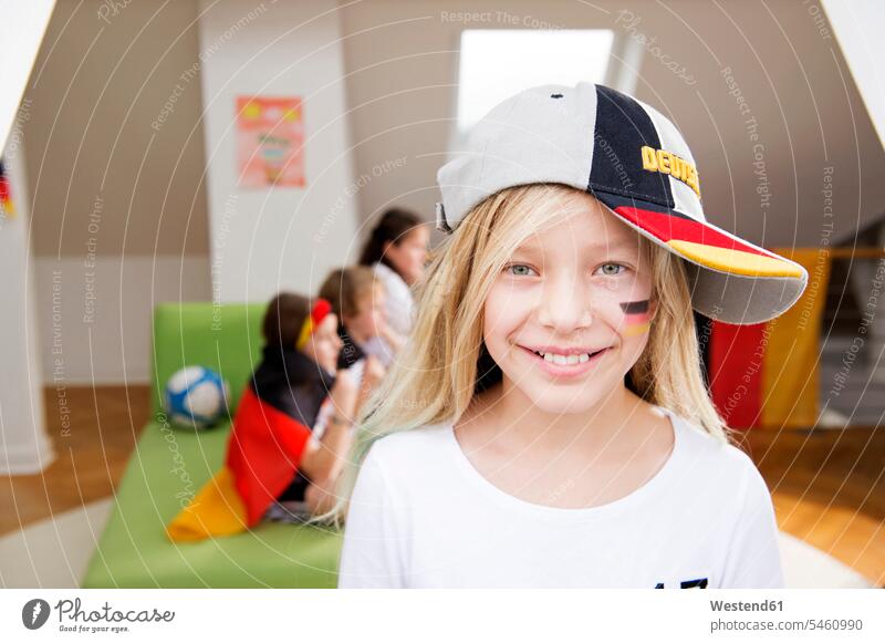 Bildnis eines Mädchens mit deutscher Gesichtsbemalung und Mütze mit Freunden im Hintergrund Fußballweltmeisterschaft Fussballweltmeisterschaft