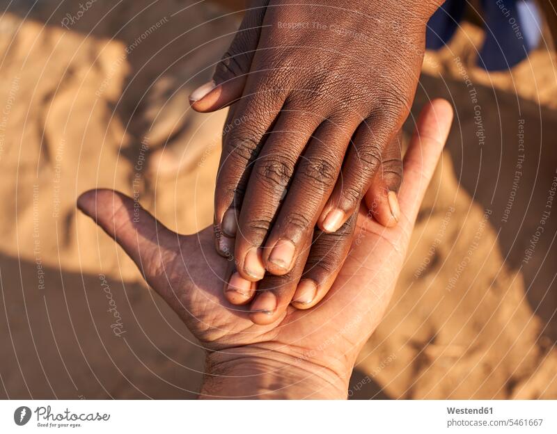 Schwarze Hände schütteln weiße Hände. Stamm der Mucubal, Tchitundo Hulo, Angola Handshake Brauchtum traditionell Gegensätze gegensätzlich Kontrast Travel außen