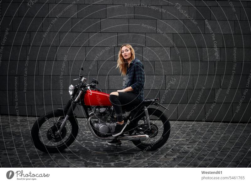Porträt einer selbstbewussten jungen Frau auf einem Motorrad Motorräder Portrait Porträts Portraits Zuversicht Zuversichtlich Selbstvertrauen Vertrauen weiblich