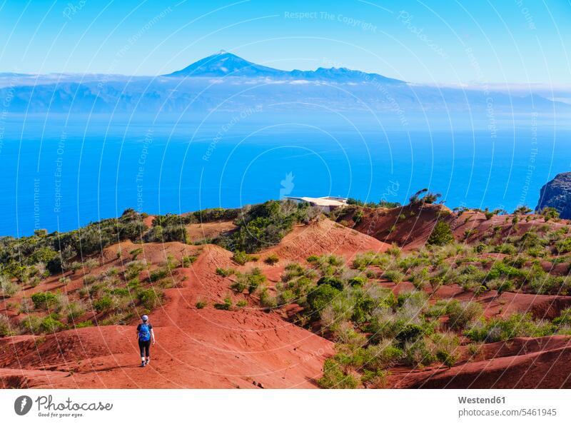 Spanien, Kanarische Inseln, Agulo, Rucksacktouristin auf dem Weg zum Beobachtungspunkt Mirador de Abrante mit dem Teide-Berg im Hintergrund Außenaufnahme außen