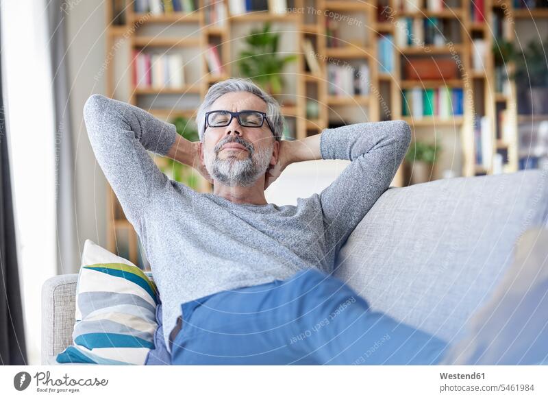 Porträt eines reifen Menschen, der sich zu Hause auf der Couch entspannt Mann Männer männlich Zuhause daheim Portrait Porträts Portraits Entspannung relaxen