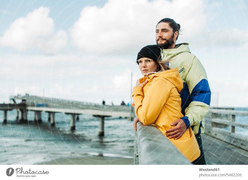 Ehepaar auf der Seebrücke in Heiligenhafen Mützen Brillen knuddeln schmusen Arm umlegen Umarmung Umarmungen gefühlvoll Emotionen Empfindung Empfindungen fühlen