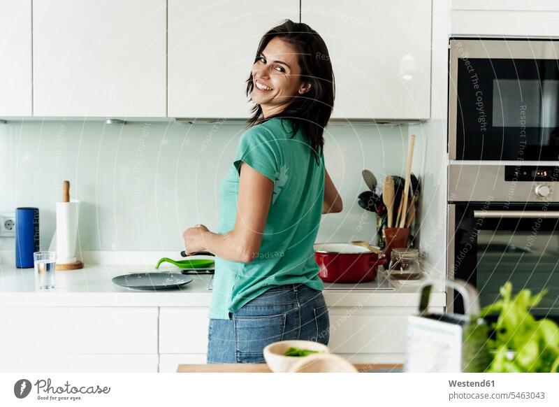 Porträt einer lächelnden Frau beim Kochen in der Küche Kochtoepfe Kochtöpfe Topf Töpfe T-Shirts Geräte Herde Kuechenherd Kuechenherde Küchenherd Küchenherde