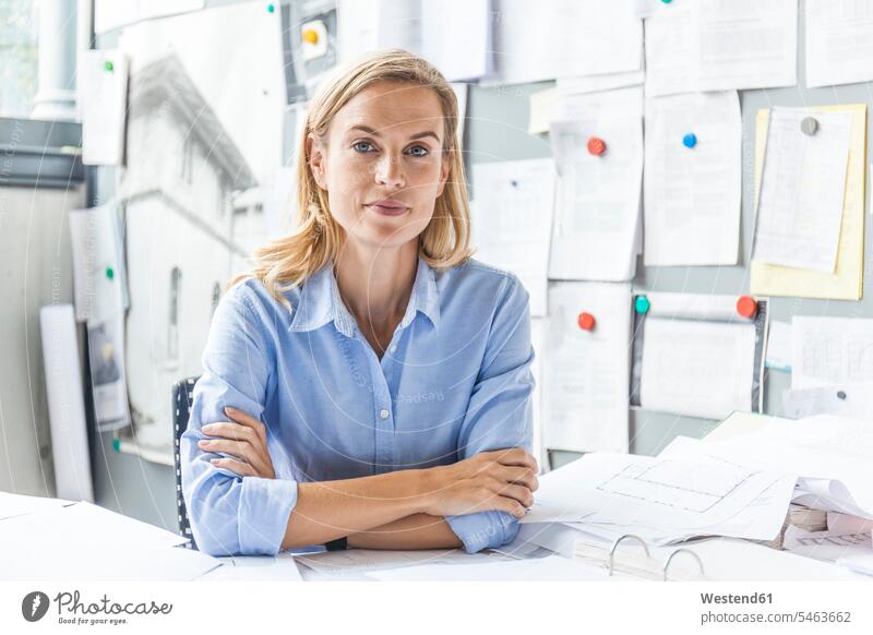 Porträt der selbstbewussten Frau sitzt am Schreibtisch im Büro von Papierkram umgeben Office Büros Zuversicht Zuversichtlich Selbstvertrauen Vertrauen weiblich