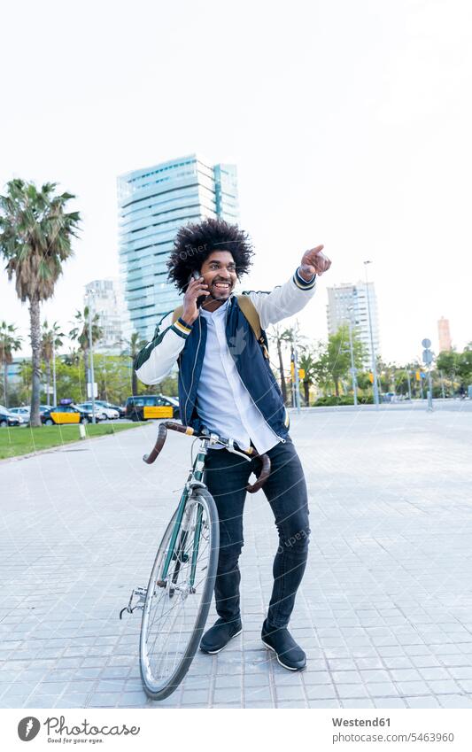 Glücklich lässigen Geschäftsmann mit Fahrrad auf Handy in der Stadt, Barcelona, Spanien Richtung Richtungen Himmel Telekommunikation sportlich Verbindung