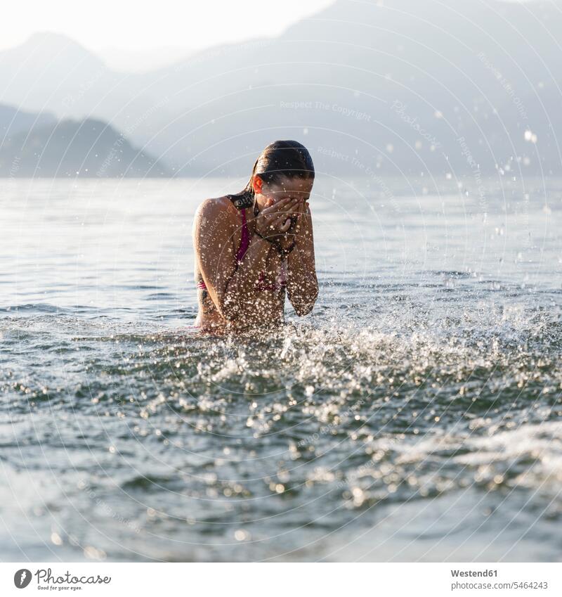 Junge Frau in einem See reibt sich die Augen Augen reiben sich die Augen reiben Seen weiblich Frauen Gewässer Wasser Erwachsener erwachsen Mensch Menschen Leute