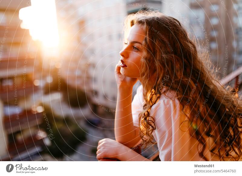 Porträt einer schönen jungen Frau auf dem Balkon bei Sonnenuntergang Leute Menschen People Person Personen Europäisch Kaukasier kaukasisch 1 Ein ein Mensch