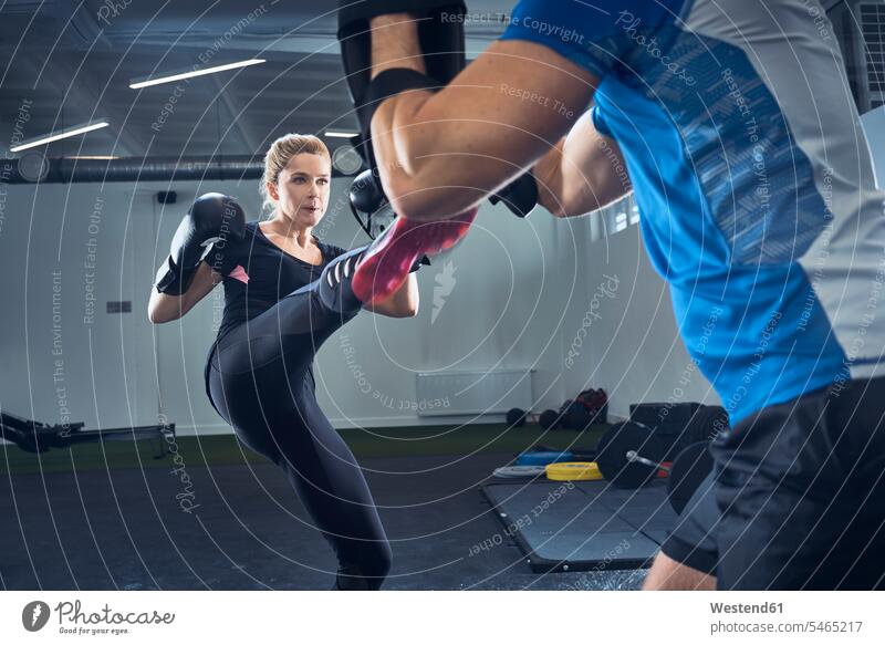Frau übt Kickboxen im Fitnessstudio Fitnessclubs Fitnessstudios Turnhalle weiblich Frauen sportlich Training trainieren Kampfsport Kampfsportart Kampfsportarten