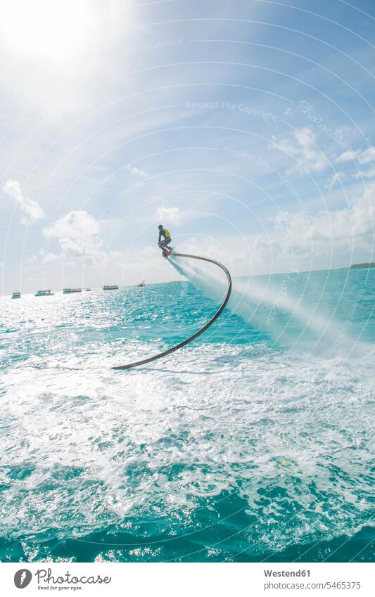 Malediven, Mann an Flyboard über dem Meer Meere Männer männlich Gewässer Wasser Erwachsener erwachsen Mensch Menschen Leute People Personen Wasserstrahl