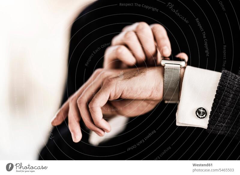Geschäftsmann überprüft die Zeit auf seiner Smartwatch Businessmann Businessmänner Geschäftsmänner auf die Uhr schauen auf die Uhr sehen Geschäftsleute