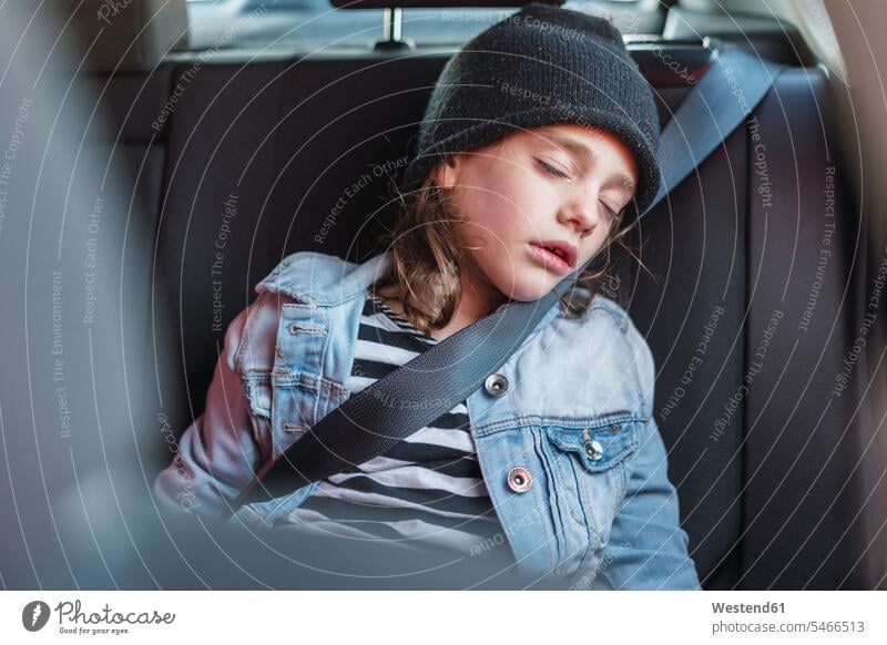 Porträt des schlafenden kleinen Mädchens auf dem Rücksitz eines Autos Mütze Mützen Textfreiraum Wollmütze Wollmützen Strickmütze Strickmützen Jeansjacke