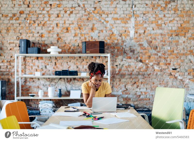 Junge Frau sitzt mit Laptop am Tisch Drahtlose Kommunikation drahtlose Verbindung schnurlose Verbindung drinnen Innenaufnahmen casual Freizeitbekleidung