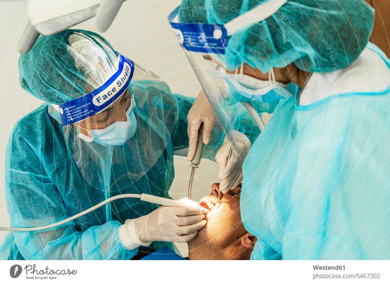 Arzt und Krankenschwester untersuchen Patient in Zahnarztpraxis Farbaufnahme Farbe Farbfoto Farbphoto Innenaufnahme Innenaufnahmen innen drinnen Spanien