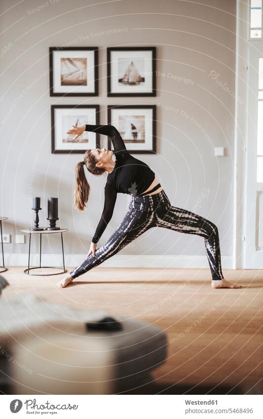 Frau praktiziert Yoga zu Hause daheim Muße trainieren bewegen sich bewegen Grund Land Raum Räume Wohnen Wohnraum Wohnräume Wohnung Wohnungen außen draußen