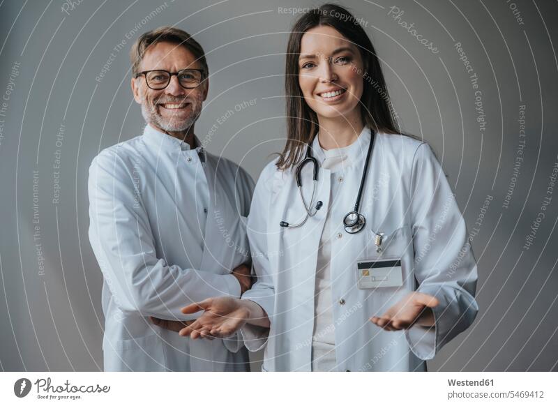 Lächelnde Ärzte stehen im Krankenhaus an der Wand Farbaufnahme Farbe Farbfoto Farbphoto Innenaufnahme Innenaufnahmen innen drinnen Wissenschaft Wissenschaften