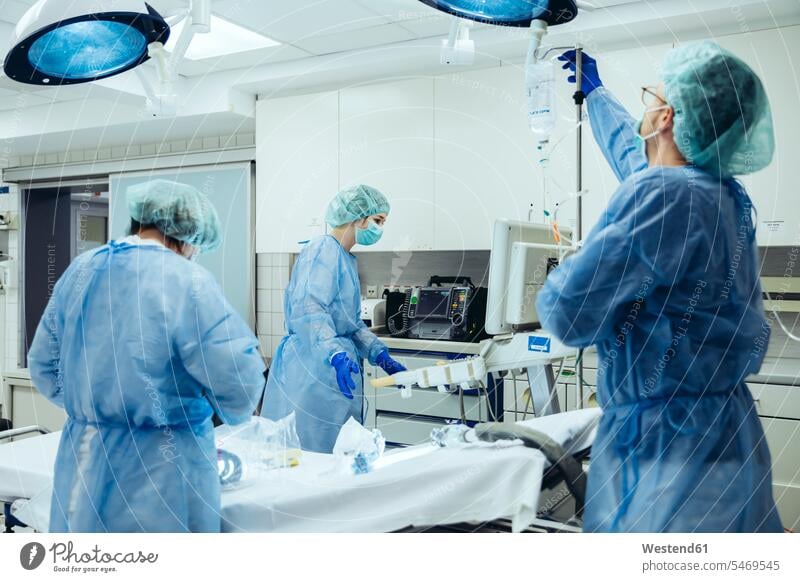 Arzt bereitet IV-Tropf im Traumaraum eines Krankenhauses vor Arbeitskollege Arbeitskollegen Kollege Job Berufe Berufstätigkeit Beschäftigung Jobs Gesundheit
