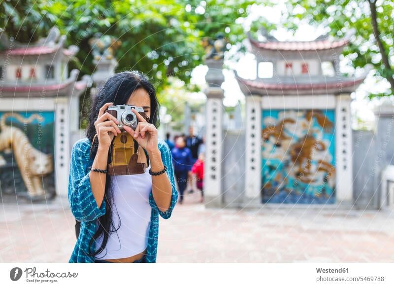 Vietnam, Hanoi, junge Frau, die mit einer altmodischen Kamera fotografiert Fotoapparat Fotokamera weiblich Frauen fotografieren Erwachsener erwachsen Mensch