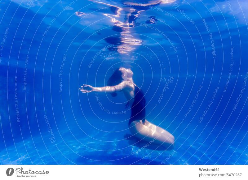 Junge Frau unter Wasser in einem Schwimmbad tauchen weiblich Frauen Unterwasser Unterwasseraufnahme Unterwasserfoto schwimmen Swimmingpool Swimmingpools