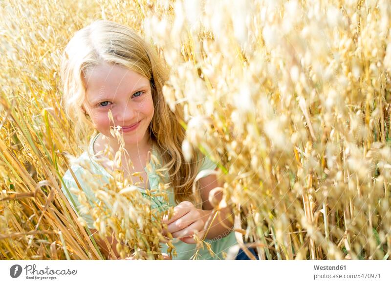 Lächelndes Mädchen steht in einem reifen Weizenfeld stehend Reife erforschen Erforschung erkunden Erkundung Wachstum Ausfluege Ausflüge Kurzurlaub außen draußen