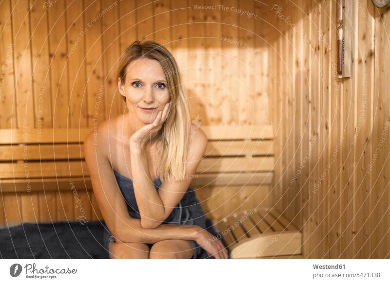 Schöne Frau mit Hand am Kinn entspannt in der Sauna Deutschland Innenaufnahme Innenaufnahmen innen drinnen Farbaufnahme Farbe Farbfoto Farbphoto