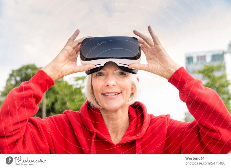 Porträt einer lächelnden älteren Frau mit VR-Brille virtuell Virtualität Brillen weiblich Frauen Erwachsener erwachsen Mensch Menschen Leute People Personen