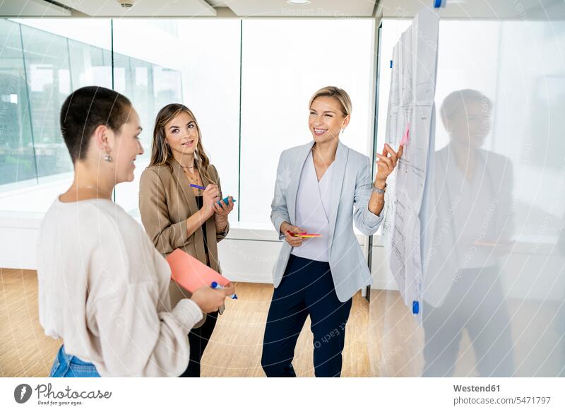 Leitende Geschäftsfrau leitet Workshop im Amt Europäer drei Personen junge Frau 20-25 Jahre 25-30 Jahre Frau mittleren Alters 35-40 Jahre Beruf Büro Business