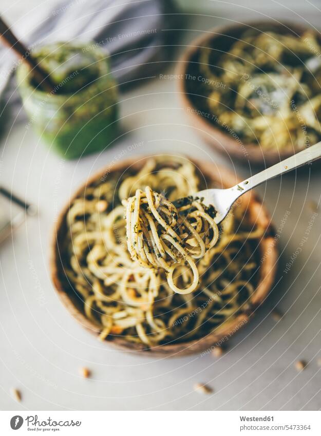 Spaghetti mit Pesto genovese auf Löffel, Nahaufnahme Schüssel Schalen Schälchen Schüsseln Pinienkerne servierfertig angerichtet selbstgemacht selbstgemachte