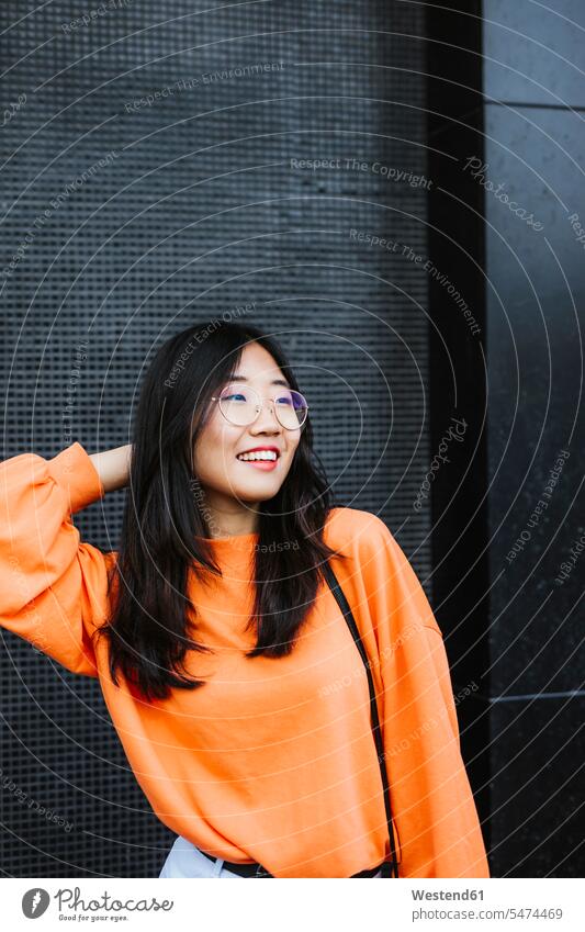 Porträt einer lächelnden asiatischen Frau mit seitlichem Blick Brillen freuen Glück glücklich sein glücklichsein zufrieden Muße Individuell außen draußen