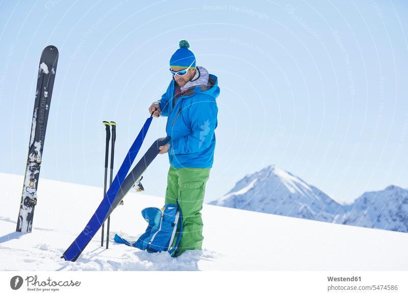 Skitourengeher, der in den Bergen Pelz am Ski befestigt, Kühtai, Tirol, Österreich Brillen Sonnenbrillen winterlich Winterzeit Farben Farbtoene Farbton Farbtöne