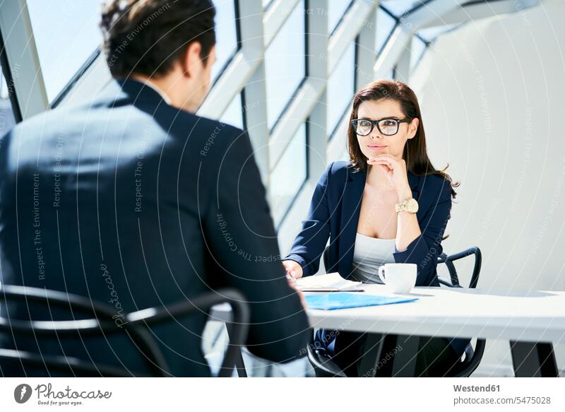 Geschäftsfrau betrachtet Geschäftsmann im modernen Büro sprechen reden Office Büros Geschäftsfrauen Businesswomen Businessfrauen Businesswoman ansehen