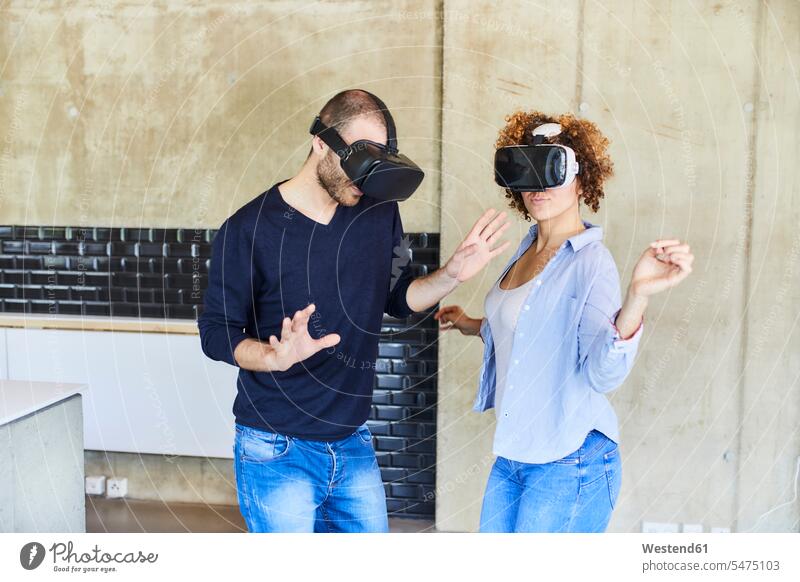 Mann und Frau mit VR-Brille bewegen sich Virtuelle Realität Virtuelle Realitaet Technologie Technologien Technik Locken lockiges Haar gelockte Haare