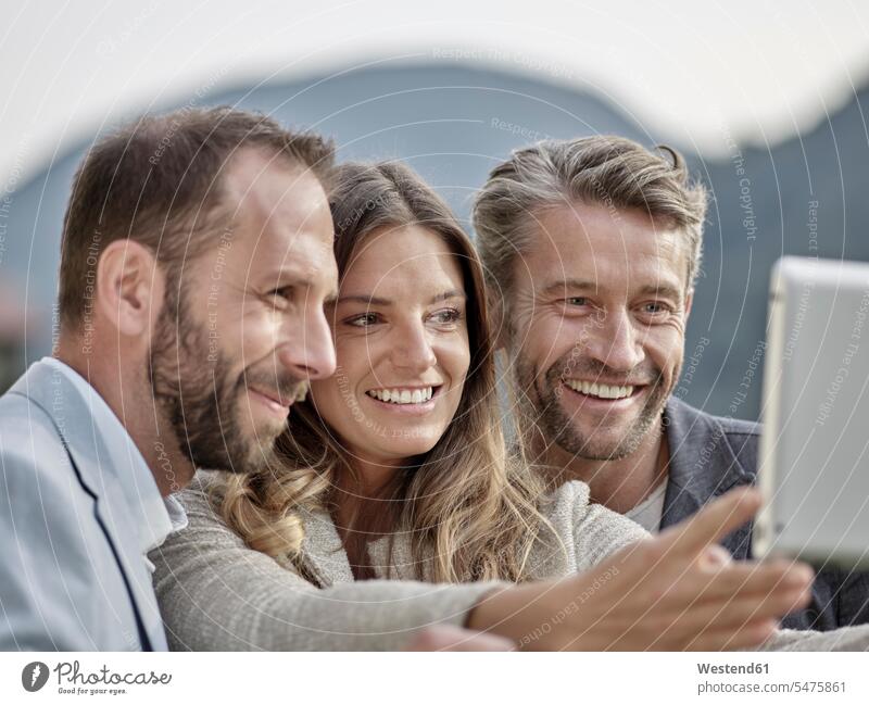 Lächelnde Kollegen machen ein Selfie lächeln Arbeitskollegen Selfies Vergnügen genießen freuen Amüsement Freude vergnügt amusieren Portrait Porträts Portraits