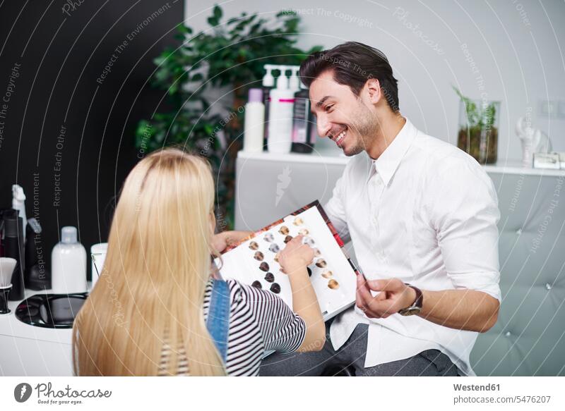 Frau wählt Haarfarbe aus der Palette im Friseursalon Friseure Frisör Frisöre weiblich Frauen Paletten Friseursalons Friseurgeschäft Friseurgeschäfte