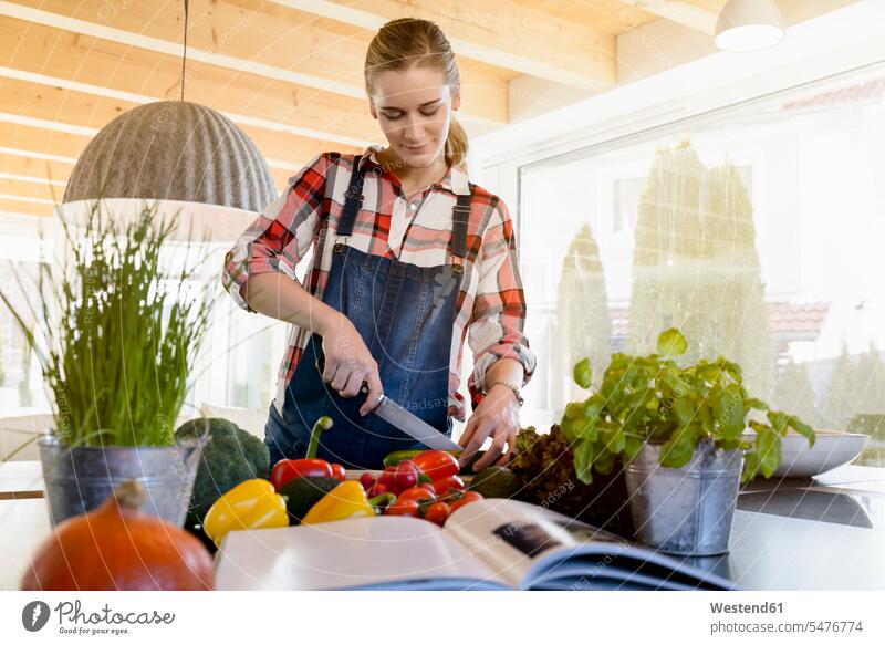 Schwangere Frau in häuslicher Küche beim Gurkenschneiden Zuhause zu Hause daheim weiblich Frauen schwanger schwangere Frau cucumis sativus Erwachsener erwachsen