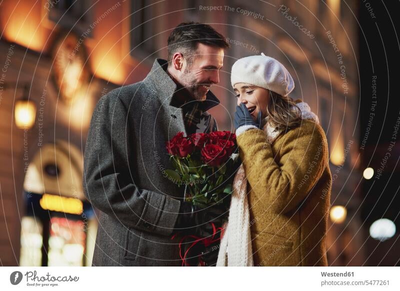 Mann schenkt seiner Freundin einen Strauß roter Rosen zum Valentinstag Blumenstrauß Bouquet Blumenstrauss Blumensträusse Blumensträuße Männer männlich Rosa
